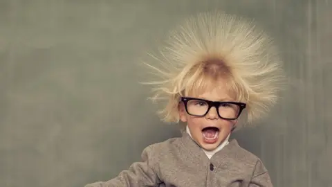 Getty Images A boy with his hair standing on end (showing static electricity)