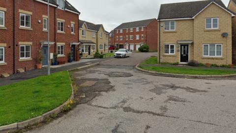 New houses but with a poor road surface outside