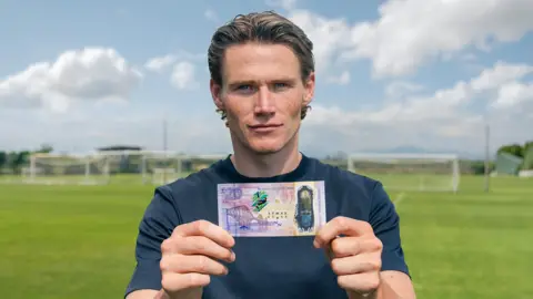 Scott McTominay with the new Bank of Scotland new limited edition £20 banknote featuring an image inspired by McTominay's overhead-kick for his now-famous World Cup qualifying goal for Scotland against Denmark.