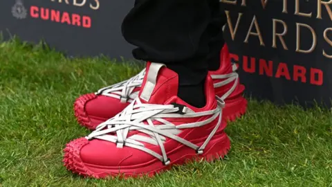 Getty Images Boy George (red trainers pictured) attends The Olivier Awards 2026 with Cunard at the Royal Albert Hall on April 12, 2026 in London, England
