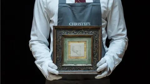 Getty Images Leonardo Da Vinci's Head of a Bear held by Christie's employee