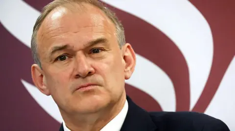 A close up of a man in a suit 