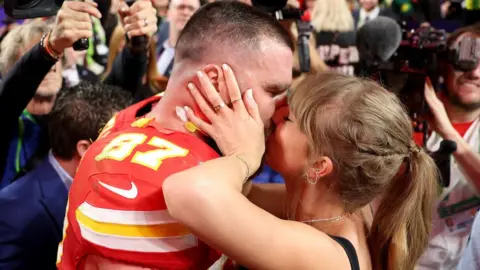 Getty Images Travis Kelce and Taylor Swift celebrate the Chiefs' Super Bowl win