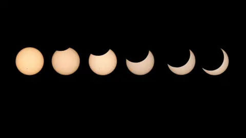 Getty Images The progression of a solar eclipse - six yellow circles against a black backdrop slowly being more obscured.
