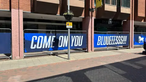 Ben Parker/BBC Banners posted on fences that read "Come on you Blues".