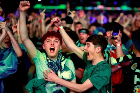 Getty Images Fans celebrate at the OVO Hydron in Glasgow.