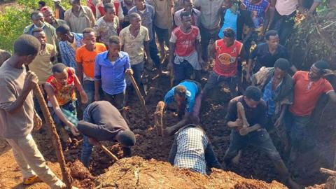 People digging at the site of two landslides in southern Ethiopia - 24 July 2024