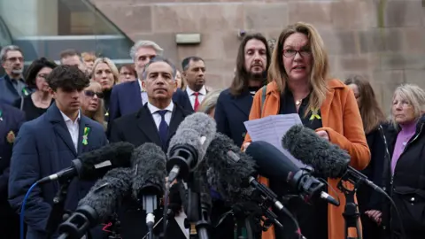 PA Media Bereaved families of the Nottingham attacks outside court.