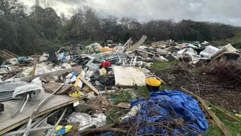 Dumped rubbish in the countryside near Gravesend including wood and plastic