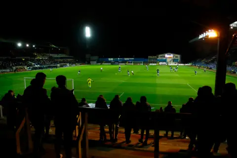 Reuters Carlisle United fans watch as their team plays Salford City