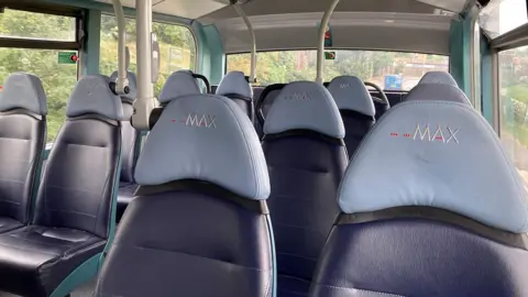 Empty blue seats inside a bus