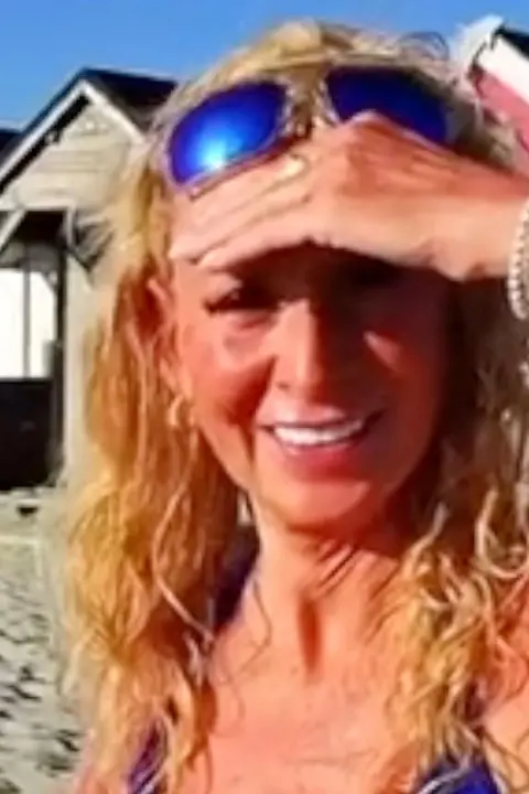 Kim is wearing blue sunglasses.