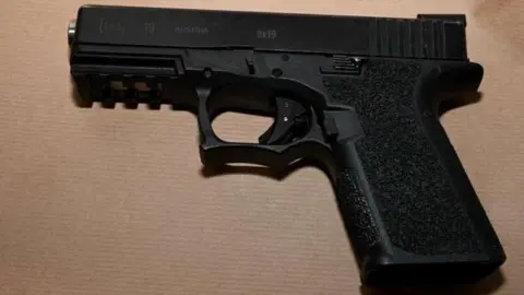 West Yorkshire Police A black handgun