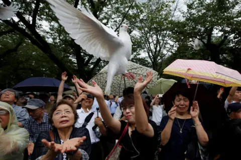 Issei Kato/ Reuters A dove flies into the sky