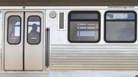 Getty Images A police investigator works inside a CTA Blue Line train parked at the suburban Forest Park station