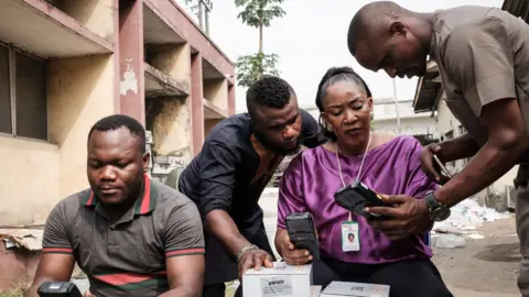 Getty Images Inec staff begin reconfiguring Smart Card Readers, that were set to work on the previous election day