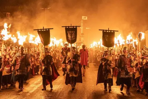 Jane Barlo/PA Media Jarl Squad participated in a torch procession through Lervik on Shetland Islands during the UP Haley AA Festival. January 28, 2025. 