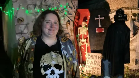 BBC Tasha Marriott outside her own Halloween display