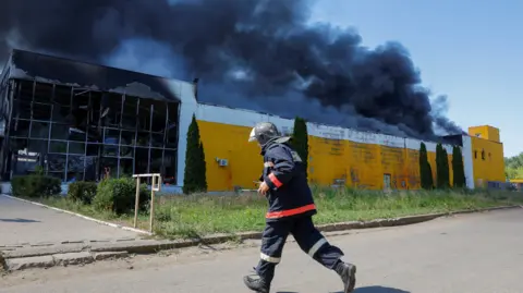 Reuters Smoke rises above the burning shopping centre in Donetsk