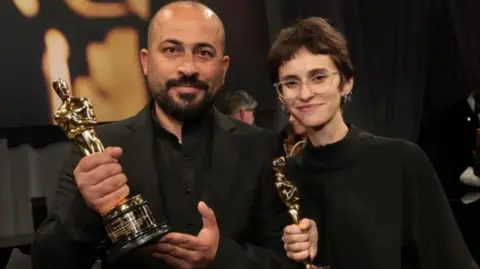 Hamdan Ballal and Rachel Szor, winners of the Best Documentary Feature Film for "No Other Land", attend the 97th Annual Oscars Governors Ball at Ovation Hollywood Complex on March 2, 2025