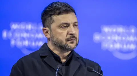 GIAN EHRENZELLER/EPA/Shutterstock Ukrainian President Volodymyr Zelensky stares out from a podium at the World Economic Forum in Davos.