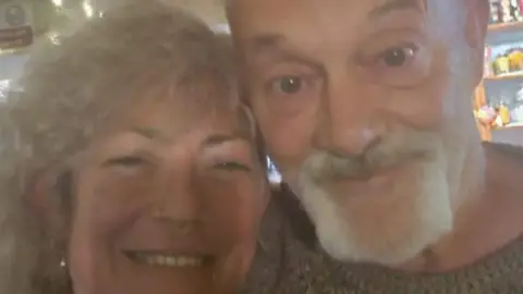Sarah Badrock A woman and a man smile for a blurred selfie