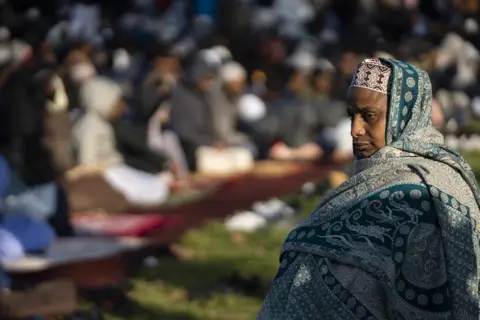 Ihsaan Haffejee/Getty Images Muslims perform the Eid al-Adha prayer at a public park in Johannesburg, South Africa