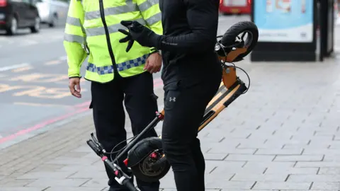 PA Man holding scooter