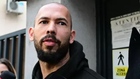 Influencer Andrew Tate speaking to journalists after being released from detention in Bucharest, Romania. 