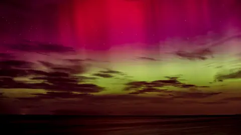 BBC Weather Watchers / R. Westerman Pink and green Northern Lights above the sea