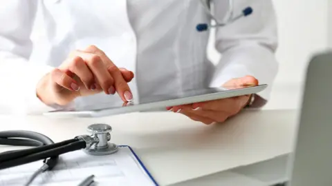 Getty Images A GP with a tablet computer