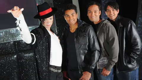 Getty Images TJ Jackson, Taryll Jackson and Taj Jackson with a Michael Jackson waxwork