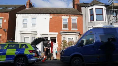 PA Media Police and forensics outside a house on Moore Street, Northampton