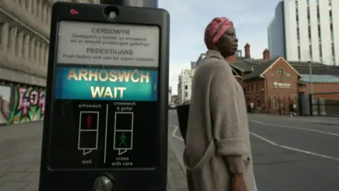 A bilingual display in English and Welsh at a pedestrian street crossing in Cardiff city centre