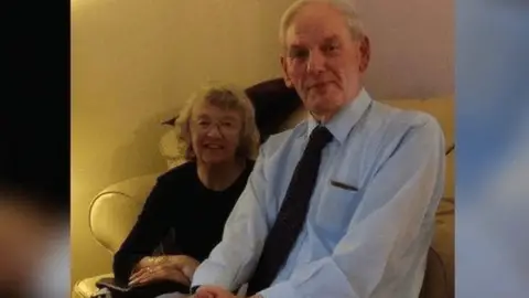 Michael Smith John Rees on right, wearing shirt and tie, with wife Eunice beside him