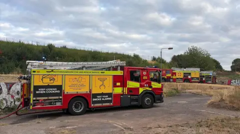 A fire engine on a piece of scrubland