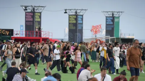 Getty Images Primavera Sound festivalgoers walk around a festival era. 