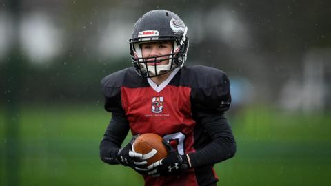 Archie in his black and red Bristol Barracudas kit in the rain