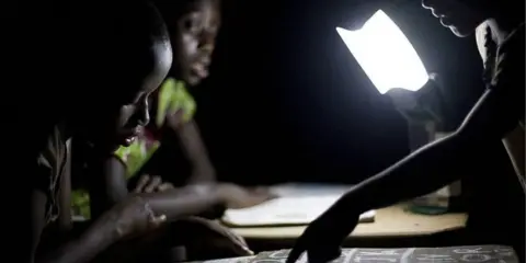 Getty Images  Children read using sola-charged lights 