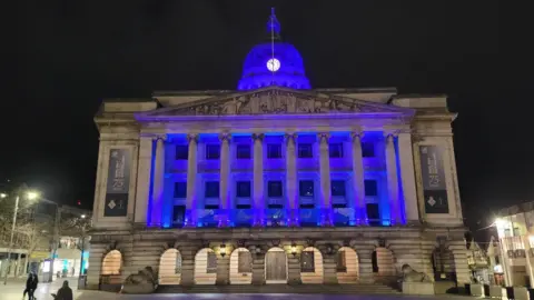 The Nottingham Council House is pictured with a blue light shining on it