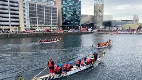 Salford City Council teams of dragon boat racers compete in Salford Quays