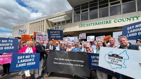 People with placards outside County Hall
