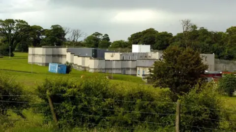 PA Media Landscape changeable  of Kerelaw residential schoolhouse  successful  Stevenston, North Ayrshire. The schoolhouse  is grey and achromatic  with a level  extortion   and is pictured down  a ligament  obstruction   and hedge row, with a enactment     of trees successful  the background.