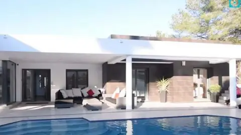 ERSOU A villa where there is a swimming poor and outdoor seating area.