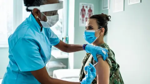 Nurse giving covid vaccine