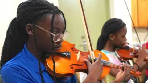 Emily James playing with the string section during a practice session ahead of October's show with the Royal Philharmonic Orchestra in London