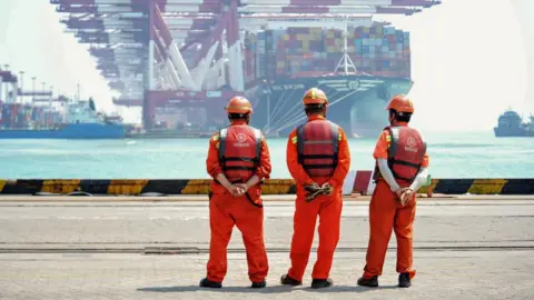 Getty Images Workers at a port in Qingdao, in China's eastern Shandong province.