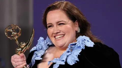 Reuters Jessica Gunning smiles and holds her Emmy award