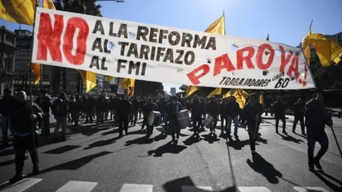 AFP Demonstrators march along 9 de Julio avenue in Buenos Aires on June 25, 2018, during a 24-hour general strike called by Argentina's unions in protest of the government's deal with the International Monetary Fund.