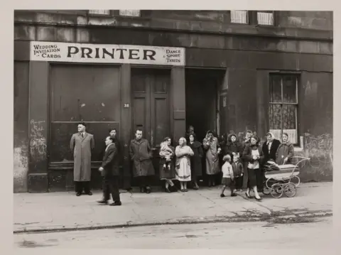 MARZAROLI COLLECTION Funeral party awaiting the hearse, Gorbals, 1963
